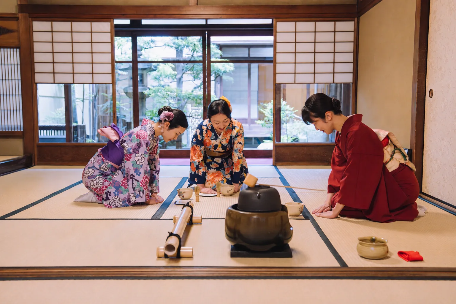 A private tea ceremony in a Kyoto tea room overlooking a garden