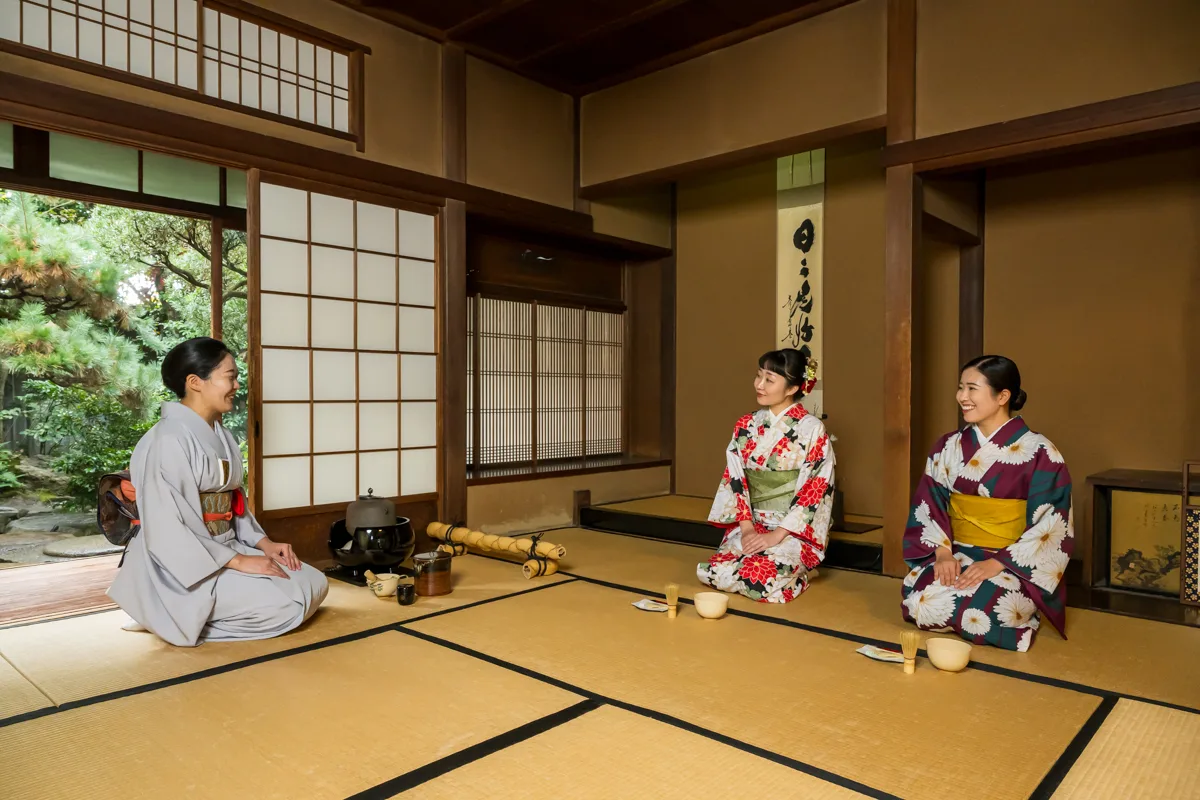 Guests watching a Japanese tea ceremony in a Kyoto tea room
