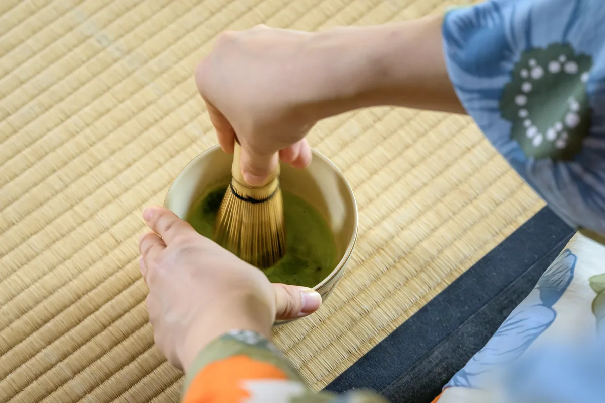 A guest whisking her own bowl of matcha