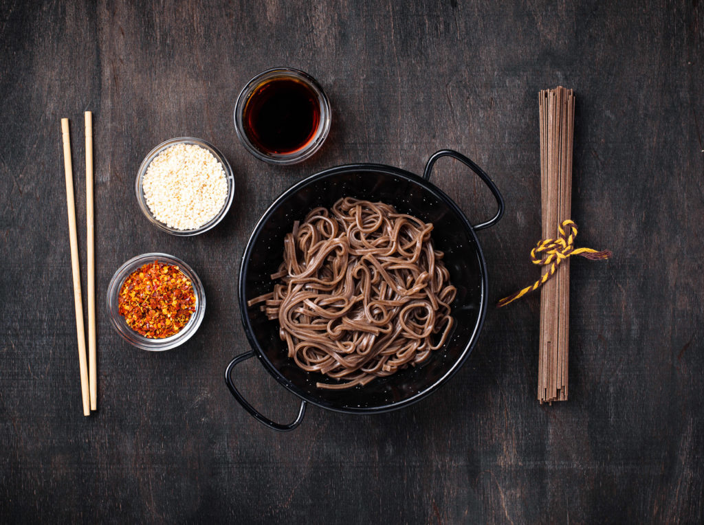 Asian noodles soba with soy sauce, sesame and chili pepper